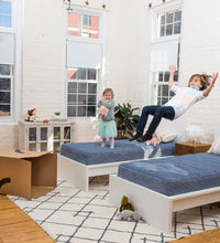 Kids jumping on loofah mattresses. 