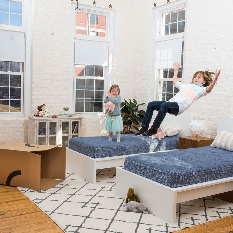 Kids jumping on loofah mattresses. 